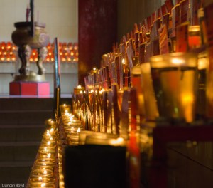 Lighting a candle in the Buddhist temple