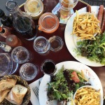 A table full of food at a typical french bistro